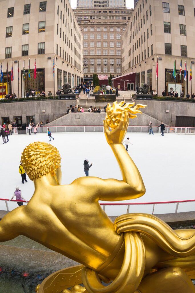 Holiday Vacation Destinations People ice skating at skating rink in Central Park.