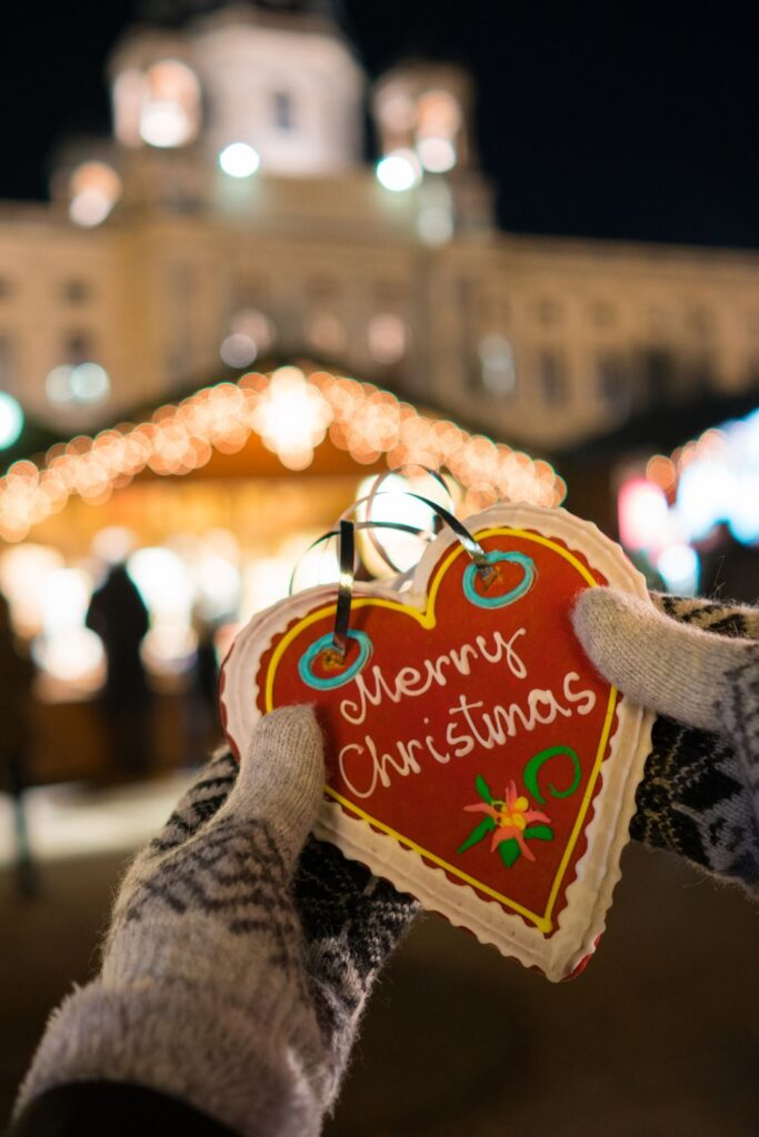 Holiday Vacation Destinations A person holding a christmas ornament,